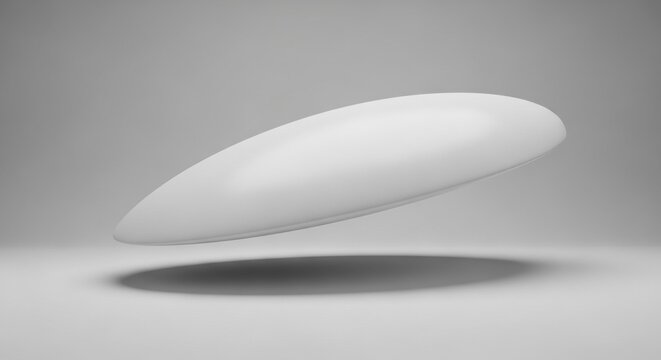 Abstract 3D render of a smooth white elliptical capsule floating above a grey surface with soft studio lighting, casting a dark drop shadow in a minimalist monochromatic setting.