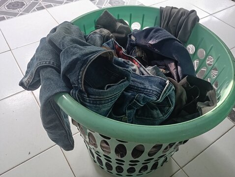 pile of dirty clothes on the bed