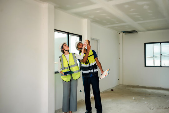Construction manager consulting home interior design palette layout with builder engineer, selecting paint tones for residential house and finishing, concept of real estate investment development.