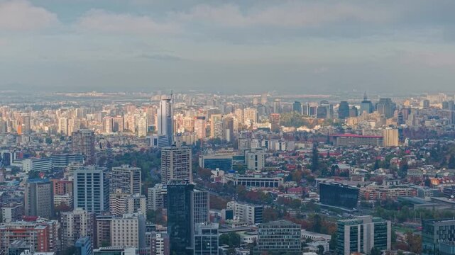 A telephoto aerial establishing view of downtown Santiago, Chile, at dawn, with the large Telefonica tower and residential buildings