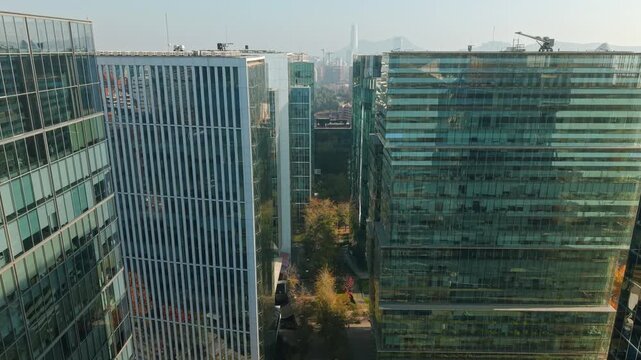 Panoramic aerial view dolly in of modern buildings in Nueva Las Condes, the financial district of Santiago, Chile, on a sunny day