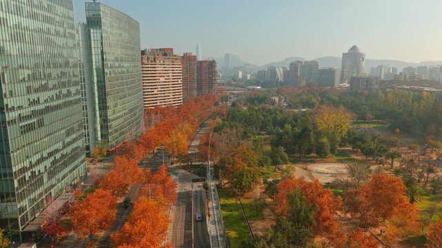 Panoramic aerial view of the modern buildings in Nueva Las Condes and Araucano Park, with orange trees in autumn in Santiago, Chile