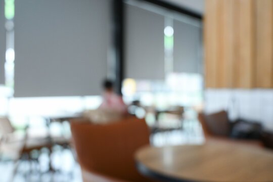 softy blurred view of a modern cafe or lounge interior featuring comfortable chair and round table