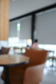softy blurred view of a modern cafe or lounge interior featuring comfortable chair and round table