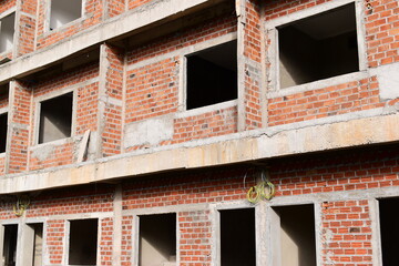 Obraz premium exterior view of brick house under construction with concrete structure
