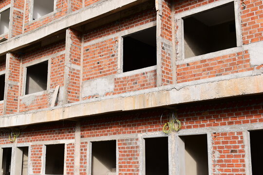 exterior view of brick house under construction with concrete structure