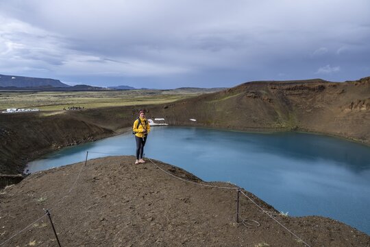 Tourist, volcanic lake, crater lake Viti at the central volcano Krafla, Myvatn, North Iceland, Iceland