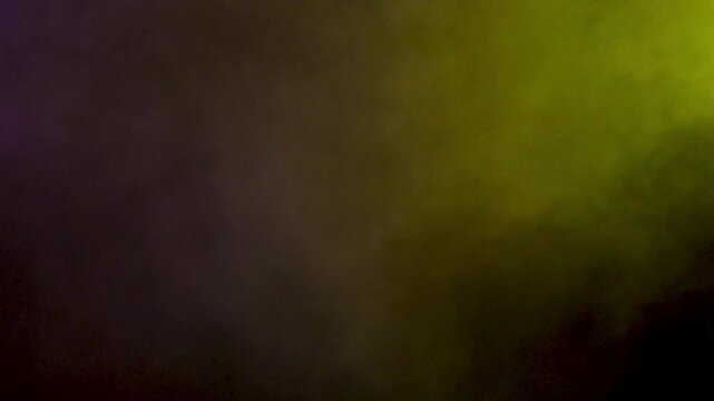Colorful smoke clouds dispersing spread through a black studio frame, mixing vapor, fog and soft haze into a textured plate for compositing and edit work.