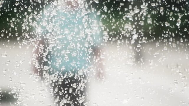 滴る噴水の水滴のスローモーション　キラキラ輝く水しぶき　夏・夏休み・水遊びの背景イメージ　