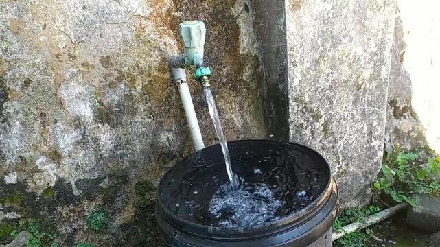clear water flowing from a tap in front of the house