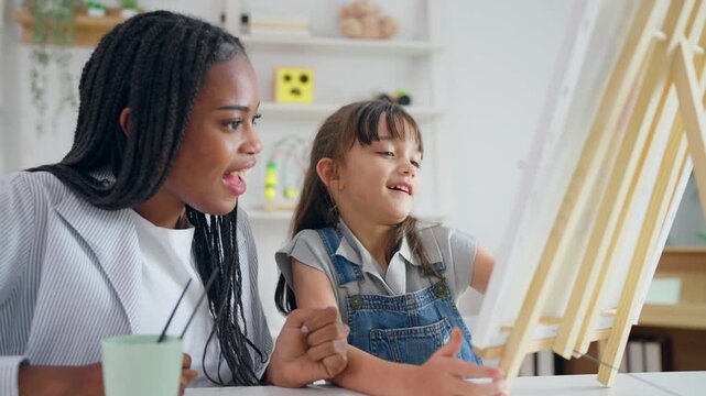 African woman tutor guide young child through art and painting in nursery. 