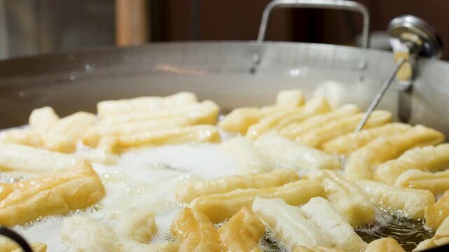 Traditional Thai Street Food Dough Sticks Frying in Hot Oil Wok