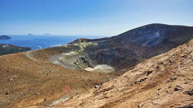 View over Vulcano crater and some of the Aeolian Islands, volcanic crater in a rocky landscape, with views of the sea and distant islands under clear skies, UNESCO World Heritage Site, Aeolian Islands, Aeolian Islands, Sicily, Italy