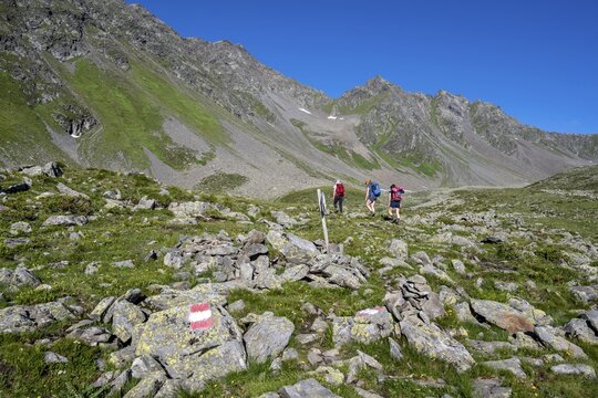 Three hikers in the Alps, Las&ouml;rling High Trail, Las&ouml;rling Group, Hohe Tauern National Park, East Tyrol, Tyrol, Austria