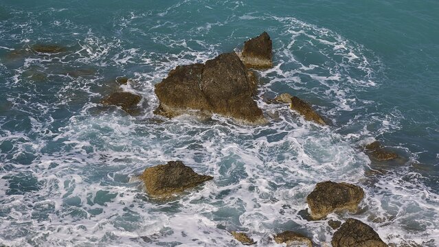 Rocks in the sea, surrounded by spray and surging waves, Atavyros beach, near Monolithos village, Rhodes, Dodecanese, Greek Islands, Greece