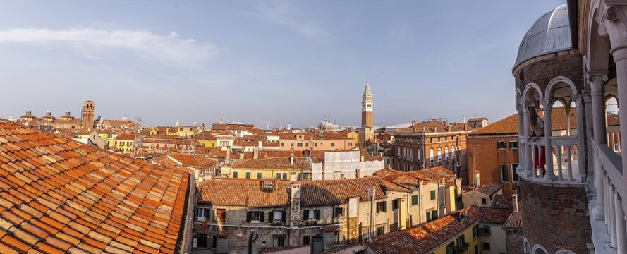 Young woman, tourist looking over Venice, dome of Palazzo Contarini del Bovolo, palace with spiral staircase, Venice, Veneto, Italy