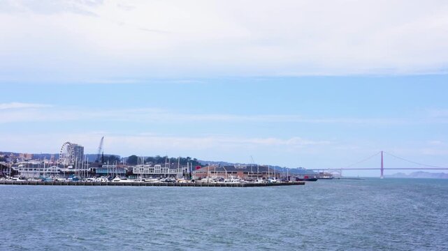 Panning across San Francisco waterfront toward Golden Gate Bridge