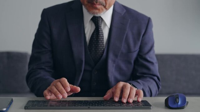 A male business professional operating a PC keyboard. Typing, engineer, programmer, system, development.