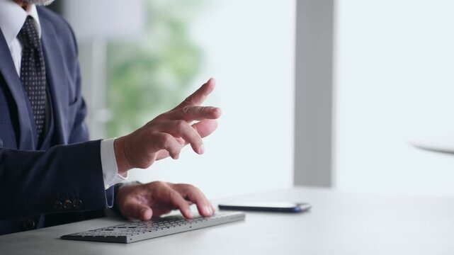 A male business professional interacting with a screen in mid-air. VR, virtual, operation, touch, office, business, development.