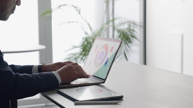 A business professional working on a laptop in an office. Desk work, office administration, engineering, work.