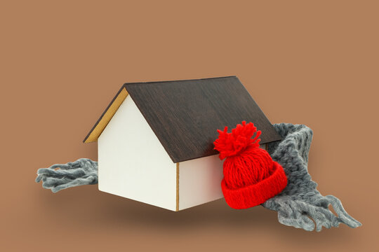 A tiny house dressed for winter with a hat and scarf