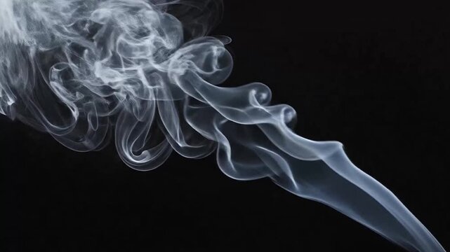 A delicate trail of white smoke swirls gracefully against a deep black background