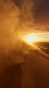 Desert Sand Dune Wind Sunset - A breathtaking view of sand dunes in the desert as the sun sets, casting a golden glow. The wind sweeps across the landscape, creating a dynamic and serene atmosphere.
