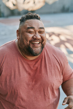 Man laughs joyfully, eyes crinkled with delight