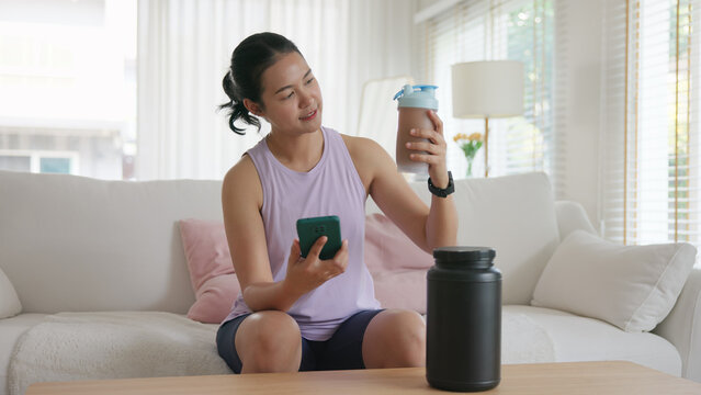 Young active Gen Z woman drink whey boost up protein shake bottle eating diet food calorie plan gain build muscle after workout. Health care asia people happy cheerful anti aging life weight loss.