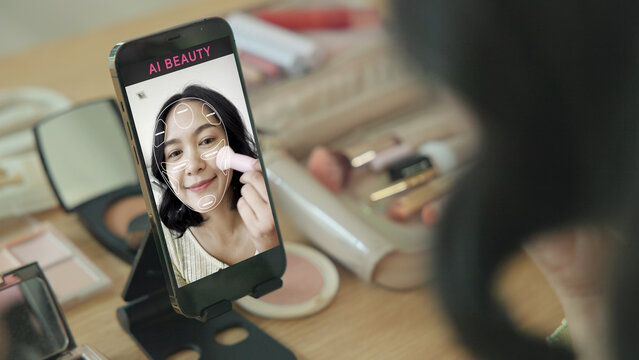 Asia people young gen z female happy smile enjoy phone apply selfie screen makeup blush virtual AI tech scan face app AR mixed augmented reality future beauty smart iot skin care help guide advice.