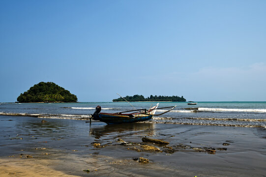 Tropical coastline with traditional fishing boat