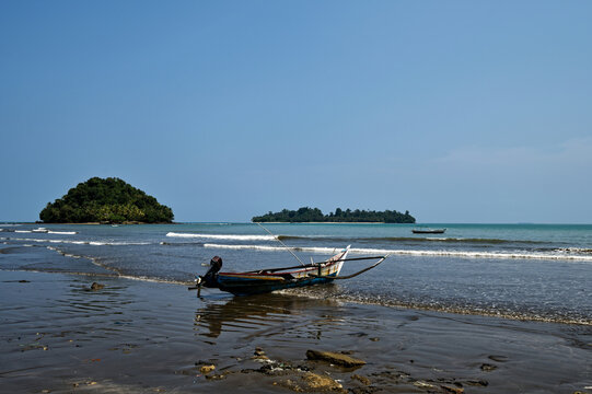 Tropical coastline with traditional fishing boat