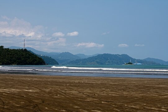 Wild tropical bay under a cloudy sky