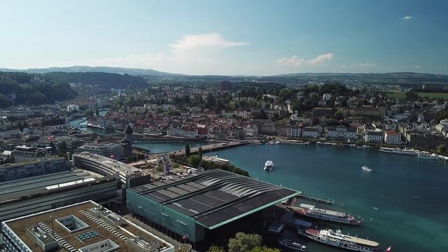 Drone descends gently over Lucerne waterfront near the marina, keeping the KKL and city center in view