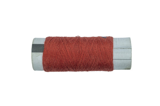 Orange spool thread sewing hobby craft supply on a transparent background.