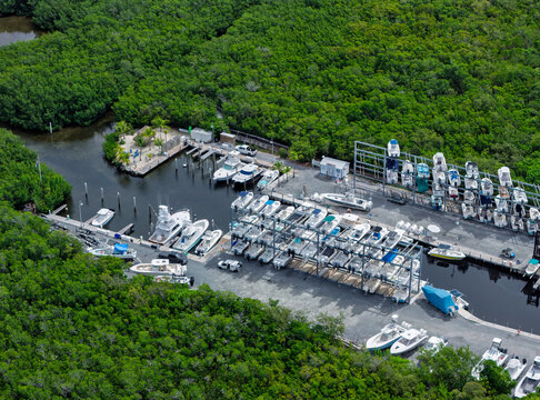 Aerial view of a marina in Islamorada with motorboats docked in the water and stored in a rack system