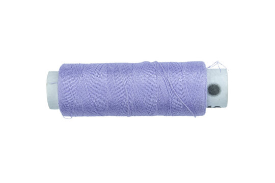One spool of purple thread for embroidery and craft projects on a transparent background.