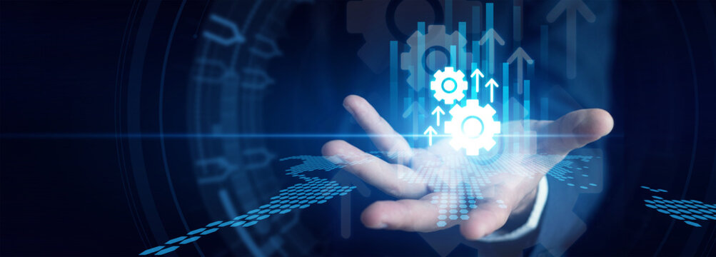 Operations leader shown by programming smart robotic factory Automation workflows on a transparent touchscreen interface to minimize manual labor. Industrial efficiency and speed upgrades.