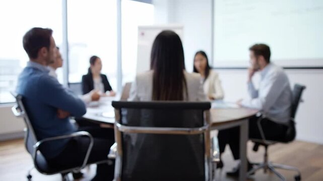 Business meeting in a modern office setting with diverse professionals collaborating around a conference table, discussing strategies and ideas