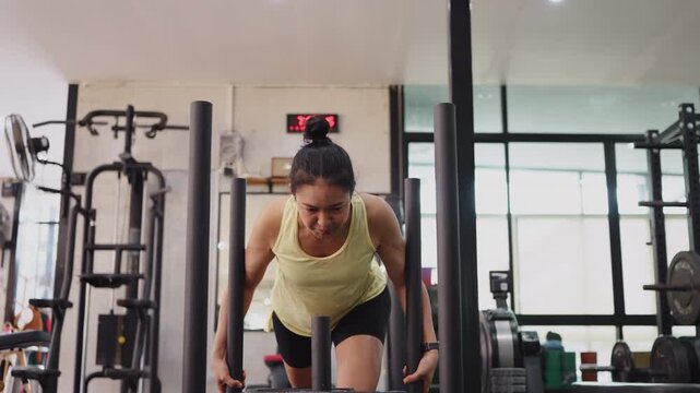 Hyrox race sled push heavy effort HIIT sport active asia people young Gen Z woman self care. High VO2 max cross power full core body glute lower leg muscle weight loss anti aging modern gym living.