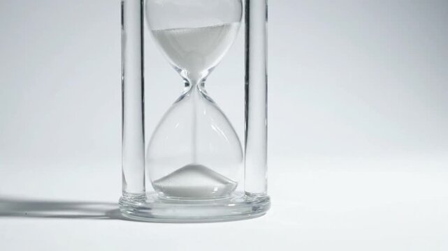 White Sand Hourglass on Neutral Background