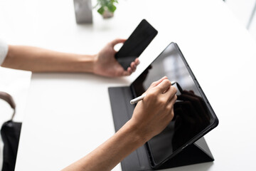 Using stylus on tablet for digital note taking and productivity technology concept. © Charlie's