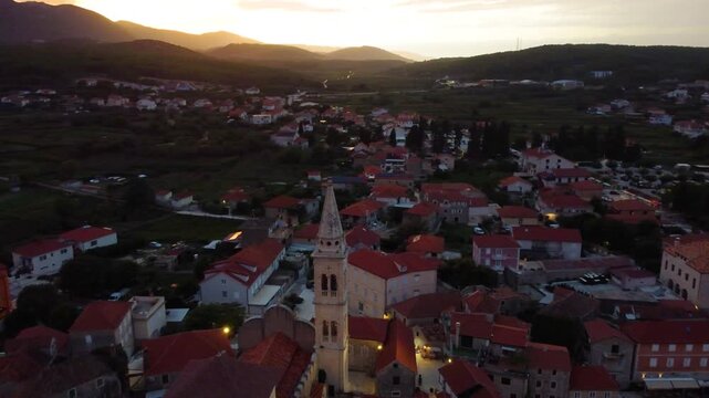 Jelsa town aerial view with church bell tower at sunset on hvar island