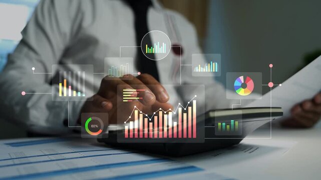 Business professional using a calculator and papers with glowing holographic graph chart animation on screen, Business finance analysis budgeting accounting and data review in a modern office