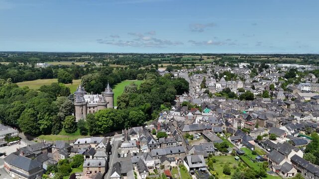 Pull back drone aerial reverse reveal Comburgh town in Brittany France