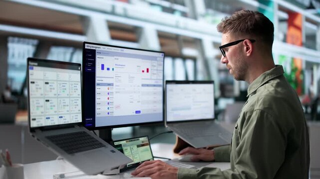 Young Man Analyzes SaaS Billing Data On Laptop