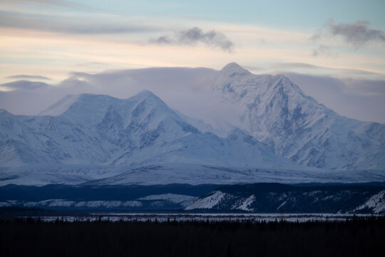 Clouds around snowy mountain in Alaska