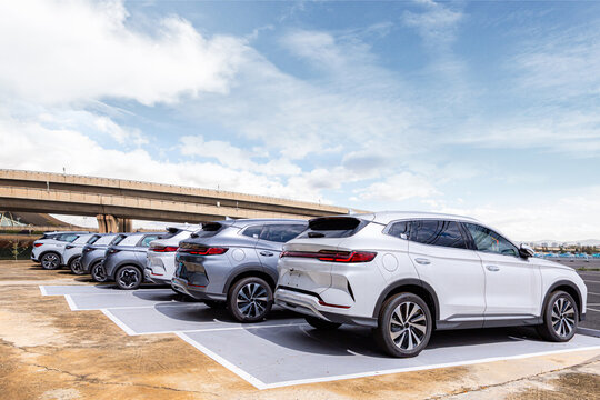Car fleet stock at dealership parking lot.  Automobile market production factory industry warehouse.
