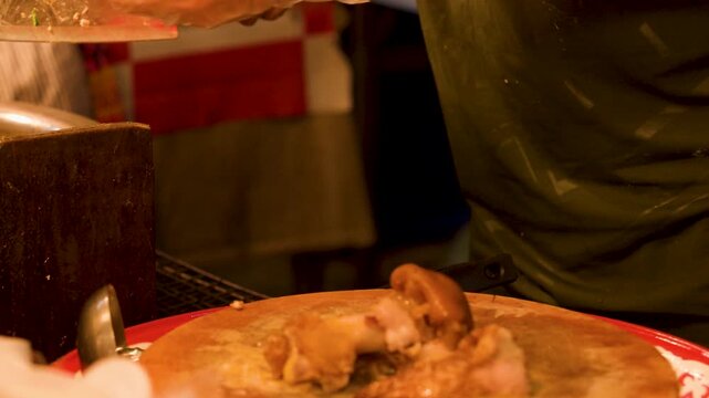 Street Food Vendor Chopping Stewed Pork Leg on Wooden Board