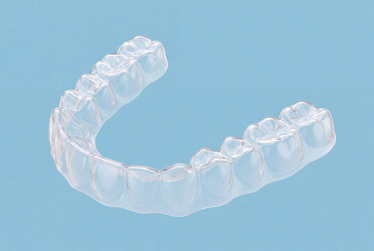 Transparent Clear Dental Aligner for Invisible Orthodontic Teeth Straightening Treatment Isolated on Blue Background with Modern Dental Care Concept